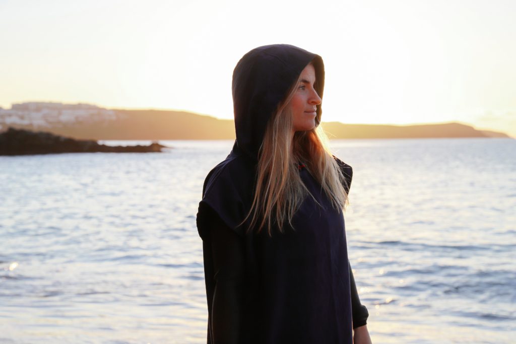 woman modelling the navy blue surf sistas poncho