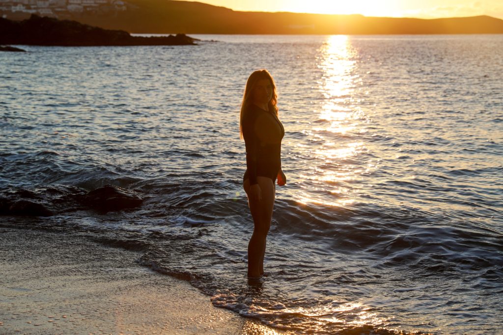 Swimmer getting in at sunset at Little Fistral