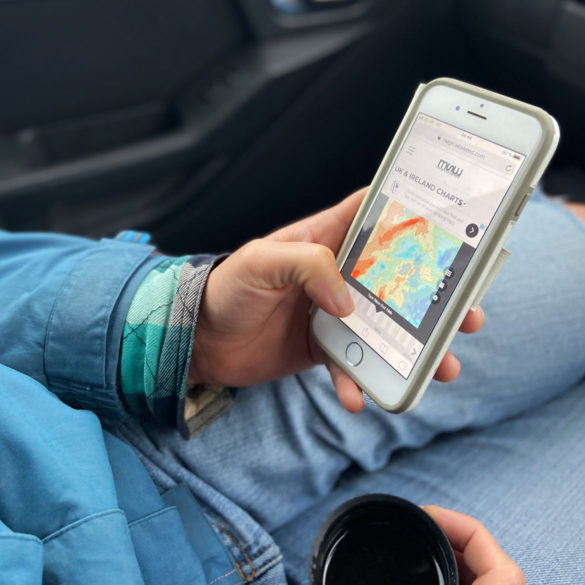 Photo of person checking the surf report on their mobile phone